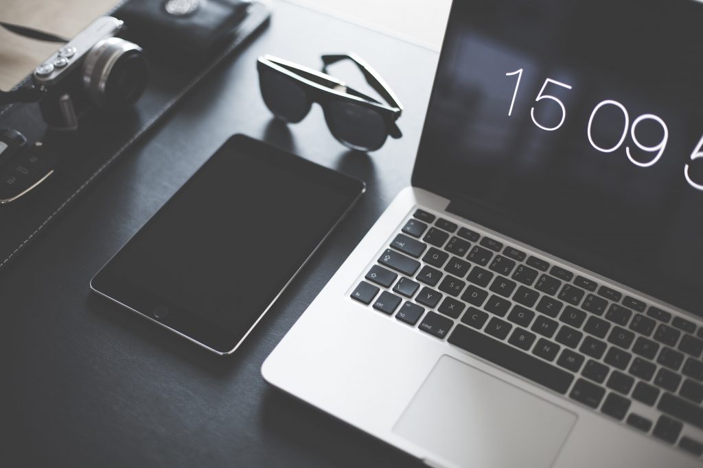 10 Signs You Should Invest in Cross Platform Apps. An image showing a mobile device, a pair of sunglasses and a laptop
