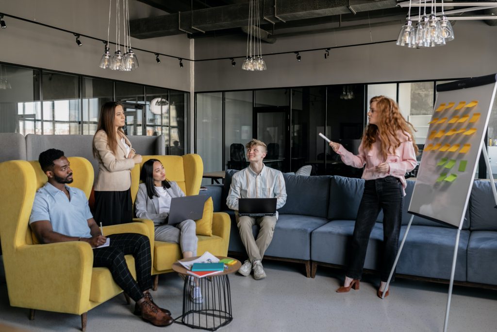 How To Build High-quality Cross-platform Apps With Agile Test Automation - a collection of people looking at a white board with some sticky notes on it